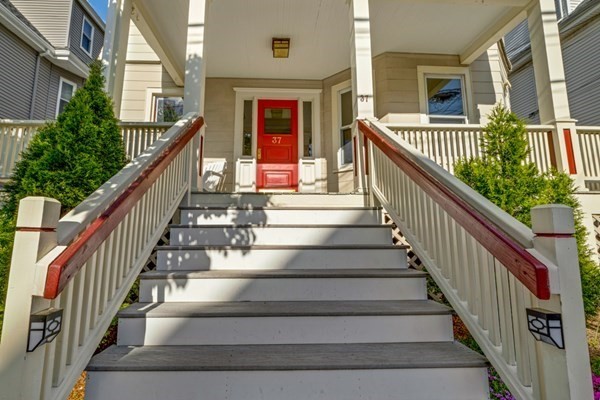37 Bromfield Road Somerville, MA 02144 - Photo 2 of 39 a view of staircase with lots of frames on wall and a wooden floor
