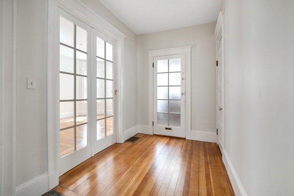 37 Bromfield Road Somerville, MA 02144 - Photo 26 of 39 an empty room with wooden floor and windows