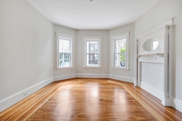37 Bromfield Road Somerville, MA 02144 - Photo 28 of 39 a view of empty room with wooden floor and fan
