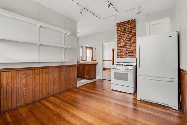 37 Bromfield Road Somerville, MA 02144 - Photo 30 of 39 a kitchen with wooden floors and white appliances