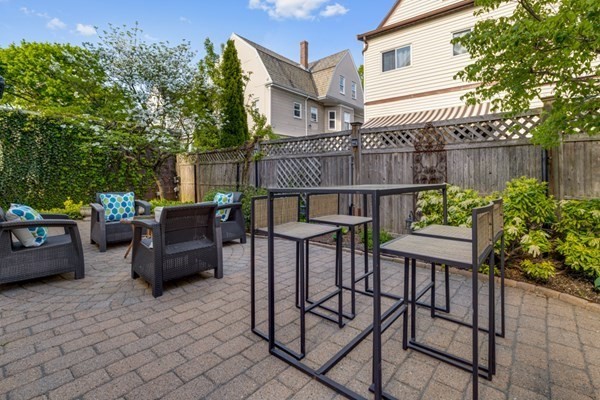 37 Bromfield Road Somerville, MA 02144 - Photo 33 of 39 a view of a chairs and table in the back yard of the house