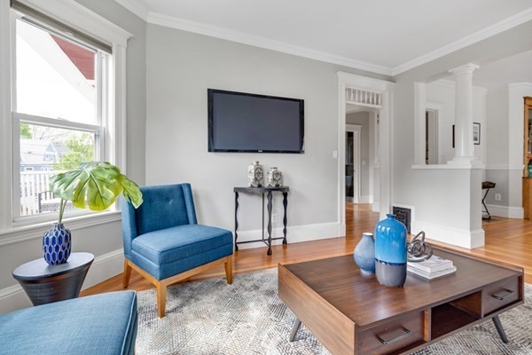 37 Bromfield Road Somerville, MA 02144 - Photo 10 of 39 a living room with furniture a flat screen tv and a window