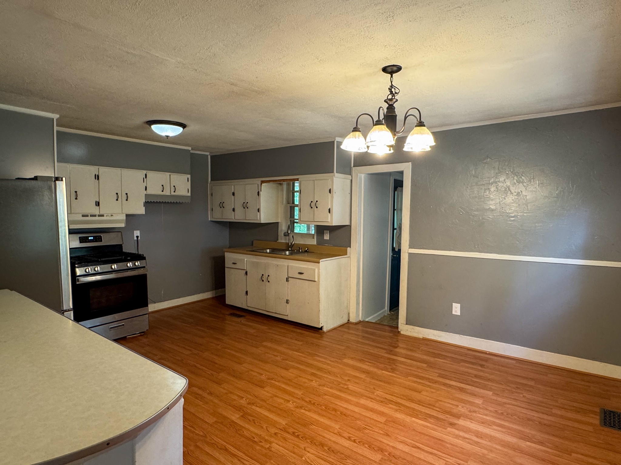 130 McFarlin Road White Bluff, TN 37130 - Photo 11 of 33 a kitchen with stainless steel appliances kitchen island granite countertop a refrigerator a stove a sink dishwasher and a refrigerator with wooden floor