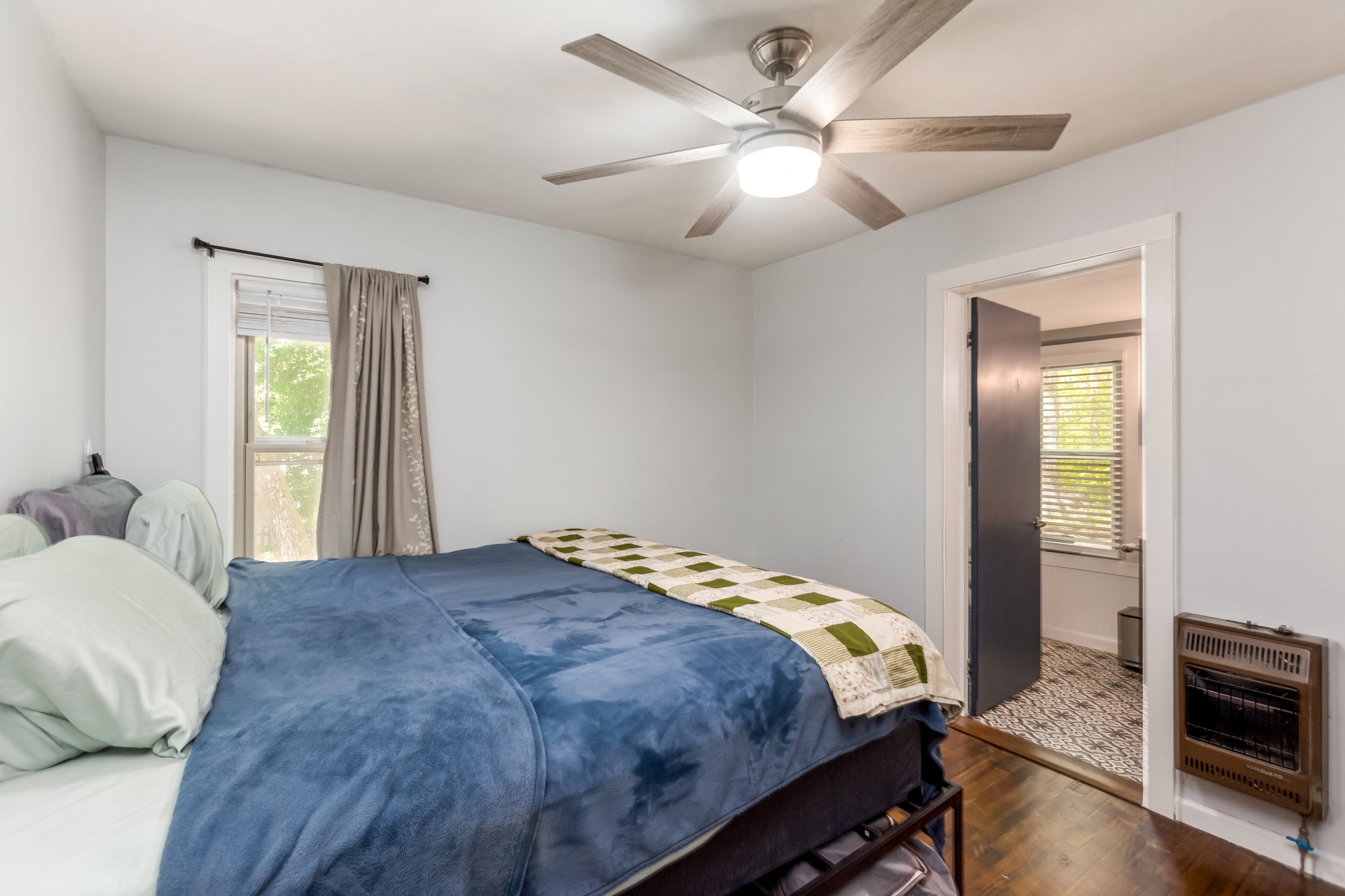 130 McFarlin Road White Bluff, TN 37130 - Photo 13 of 33 a bedroom with a large bed and a chandelier