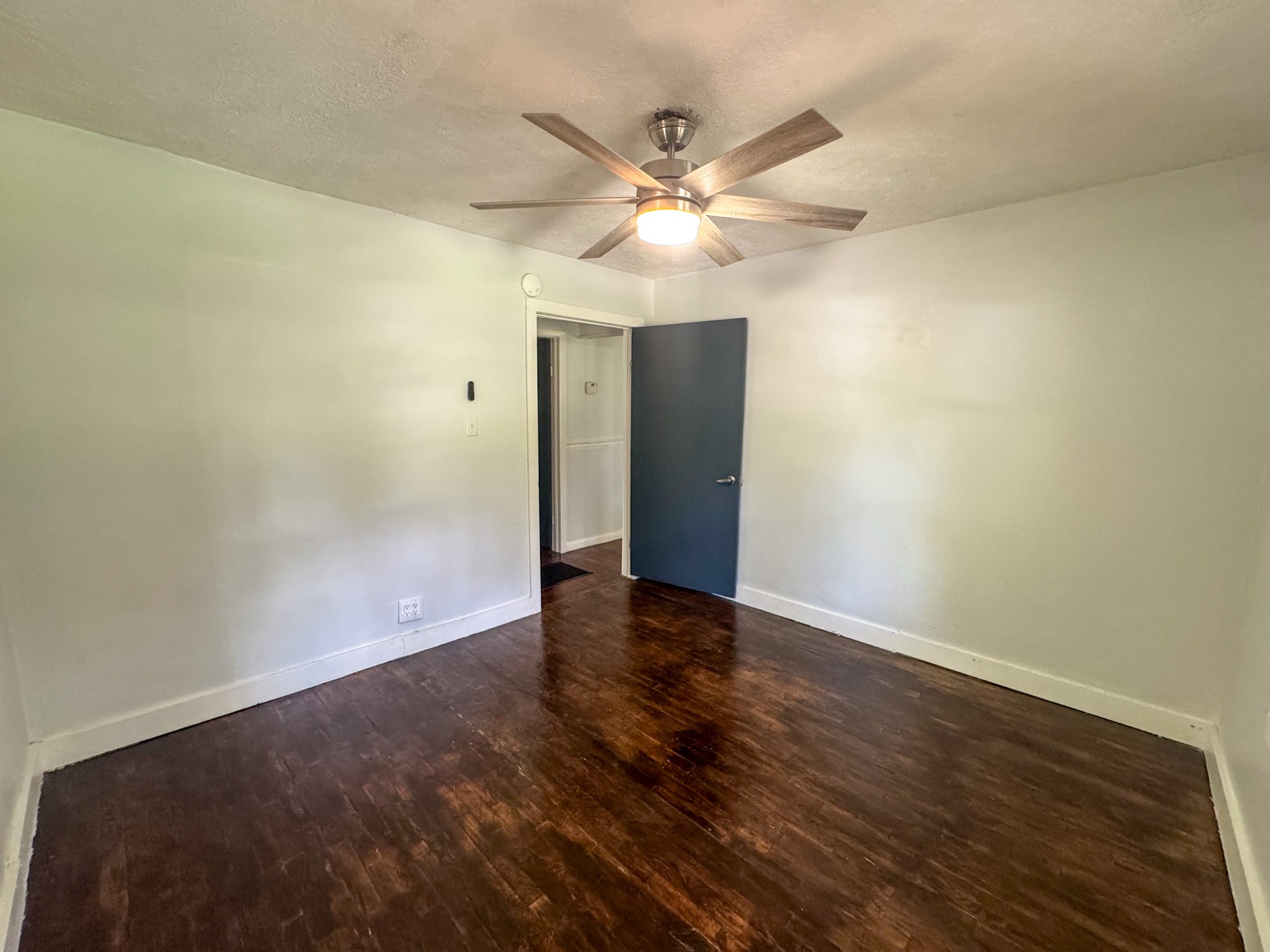 130 McFarlin Road White Bluff, TN 37130 - Photo 16 of 33 an empty room with wooden floor fan and windows