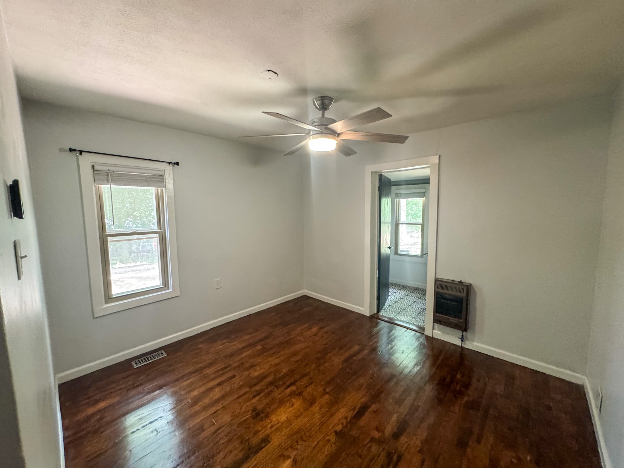 130 McFarlin Road White Bluff, TN 37130 - Photo 17 of 33 an empty room with wooden floor chandelier fan and windows