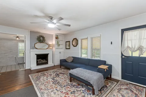 a living room with furniture and a fireplace