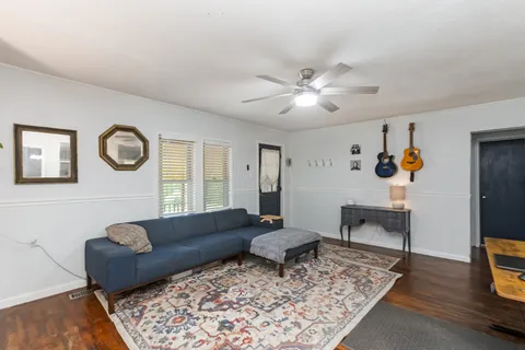 a living room with furniture and wooden floor