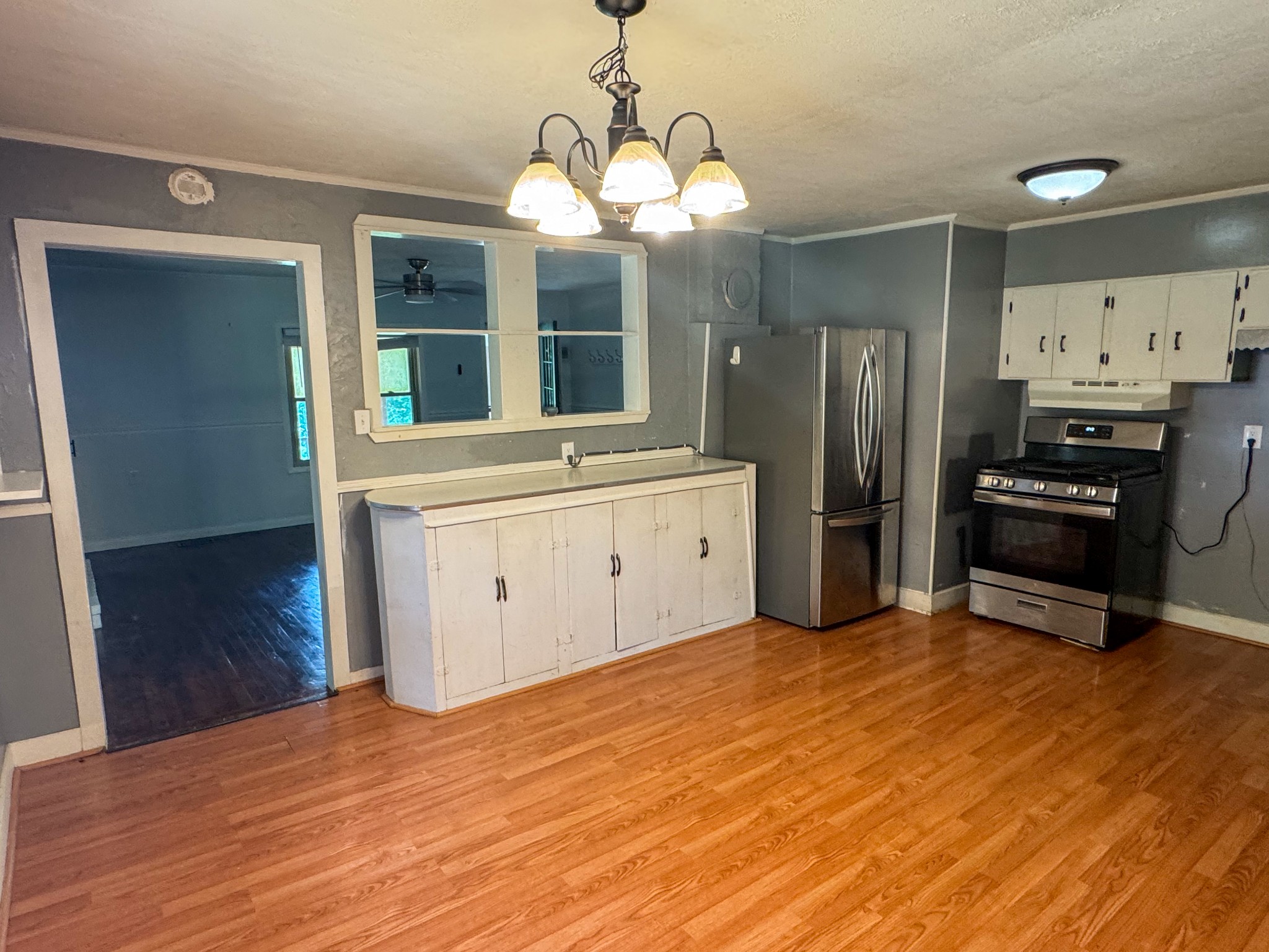 130 McFarlin Road White Bluff, TN 37130 - Photo 10 of 33 a kitchen with stainless steel appliances a sink cabinets and wooden floor