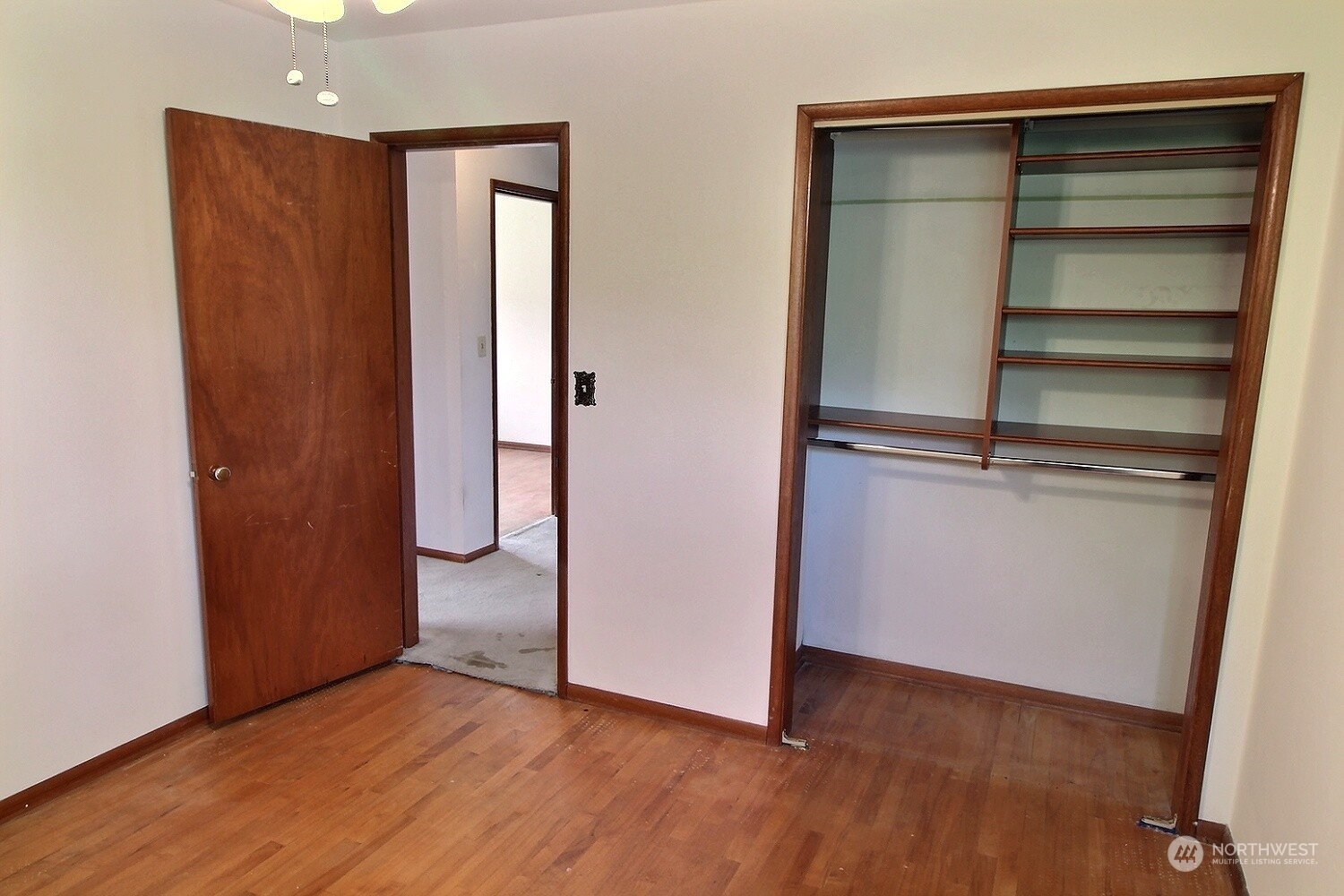 3619 Talbot Road South Renton, WA 98055 - Photo 15 of 27 a view of an empty room with wooden floor and closet