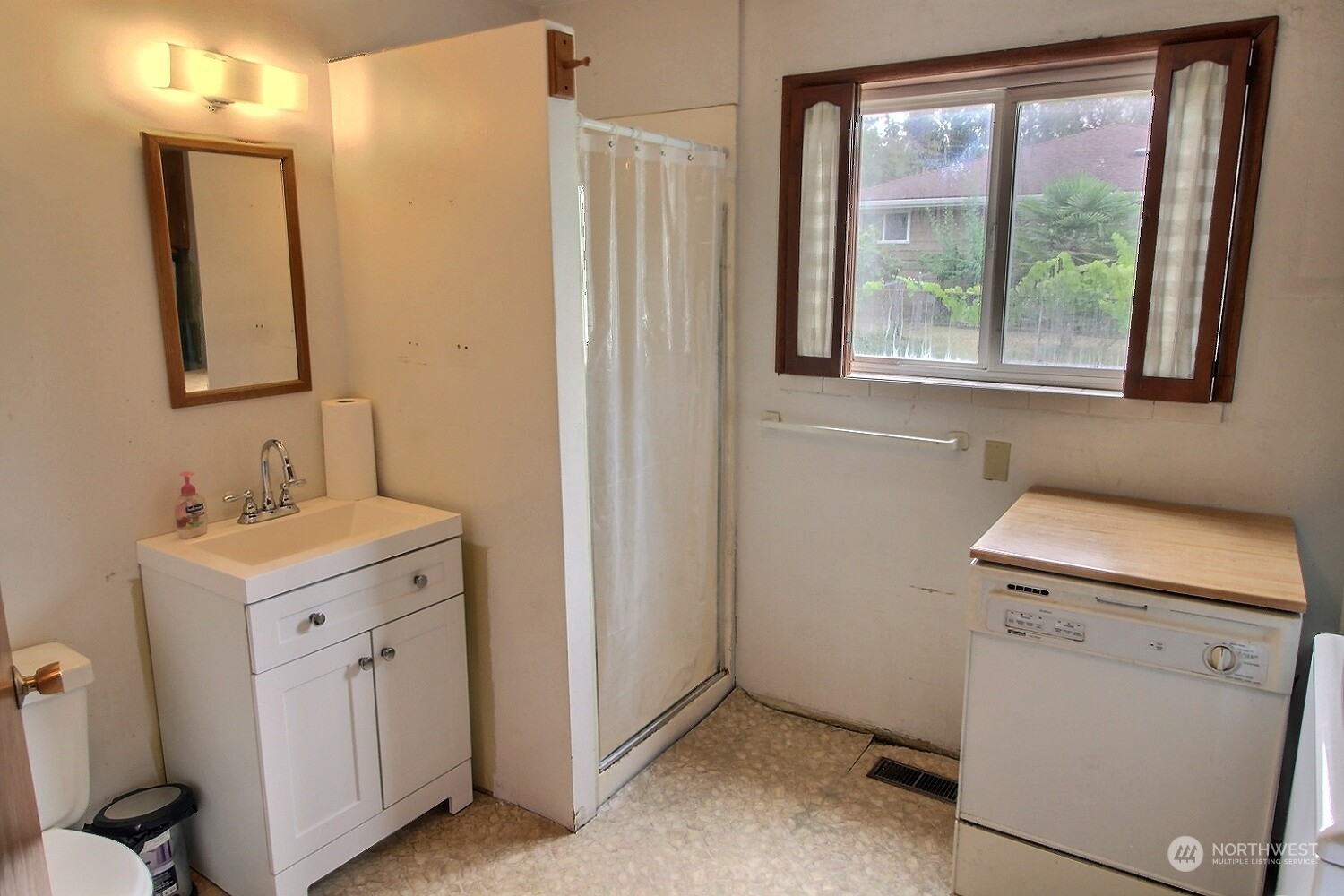3619 Talbot Road South Renton, WA 98055 - Photo 19 of 27 a bathroom with a sink a toilet and a mirror