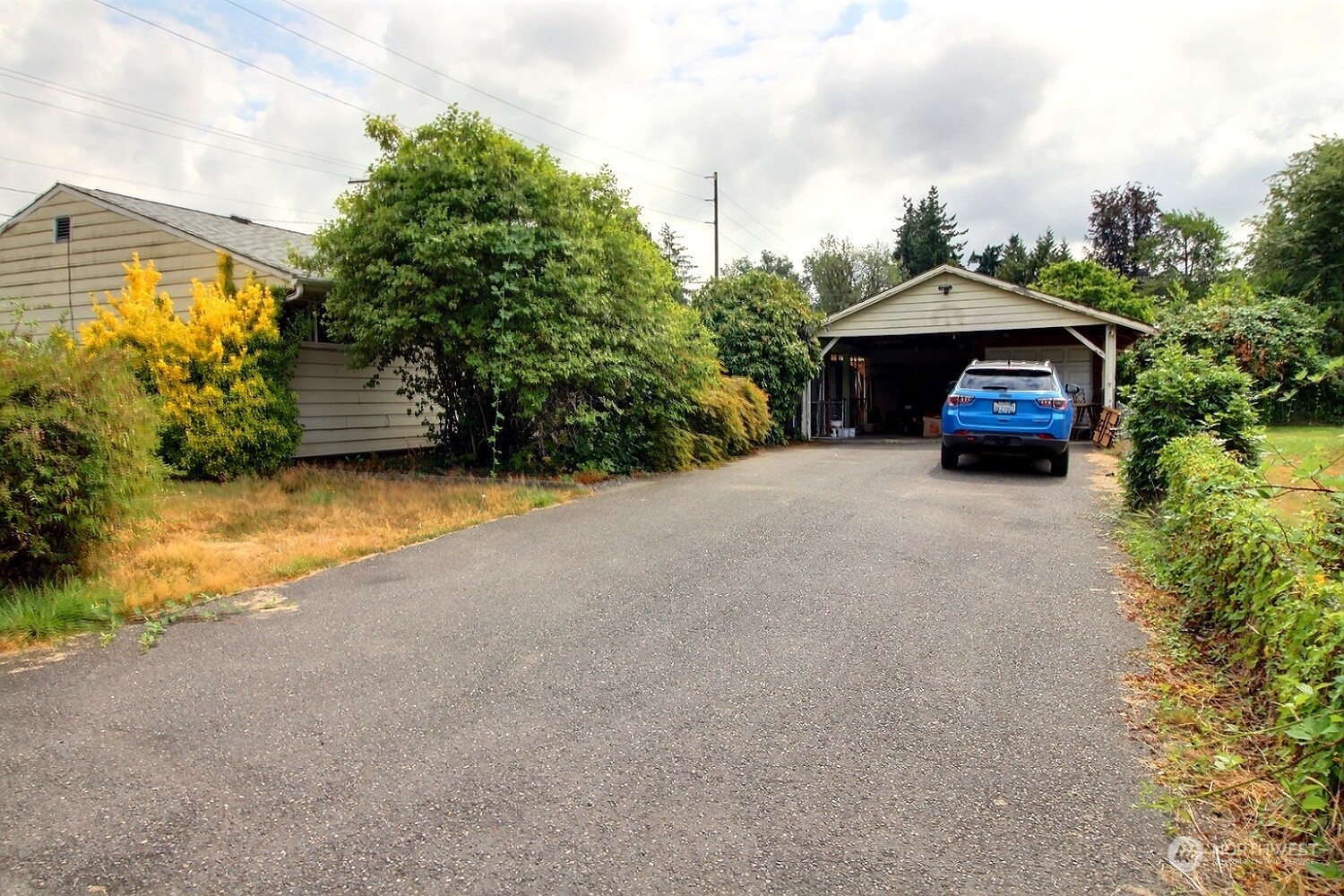 3619 Talbot Road South Renton, WA 98055 - Photo 23 of 27 a small yard with a table and chairs under an umbrella