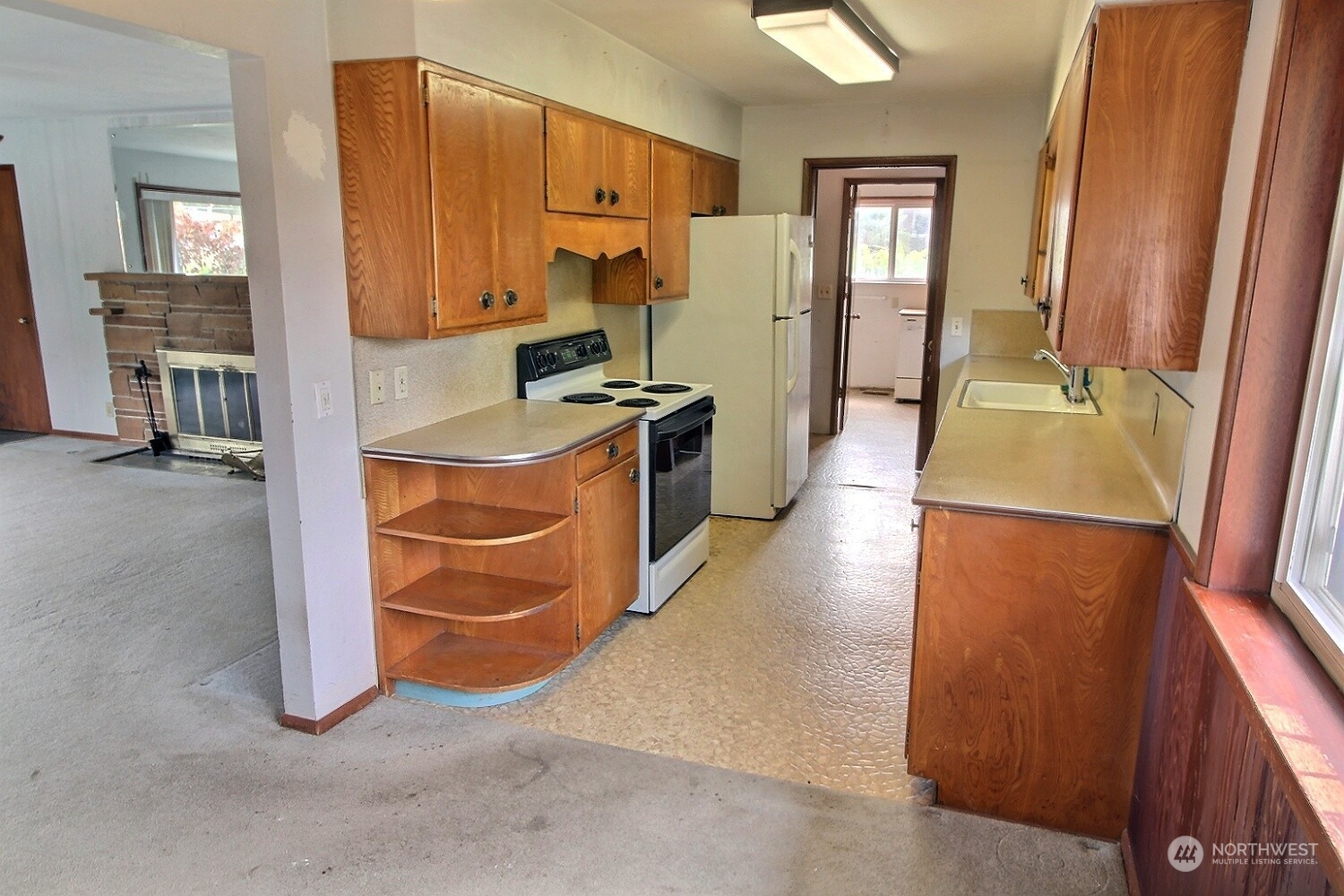3619 Talbot Road South Renton, WA 98055 - Photo 4 of 27 a kitchen with stainless steel appliances granite countertop a refrigerator a stove and a sink