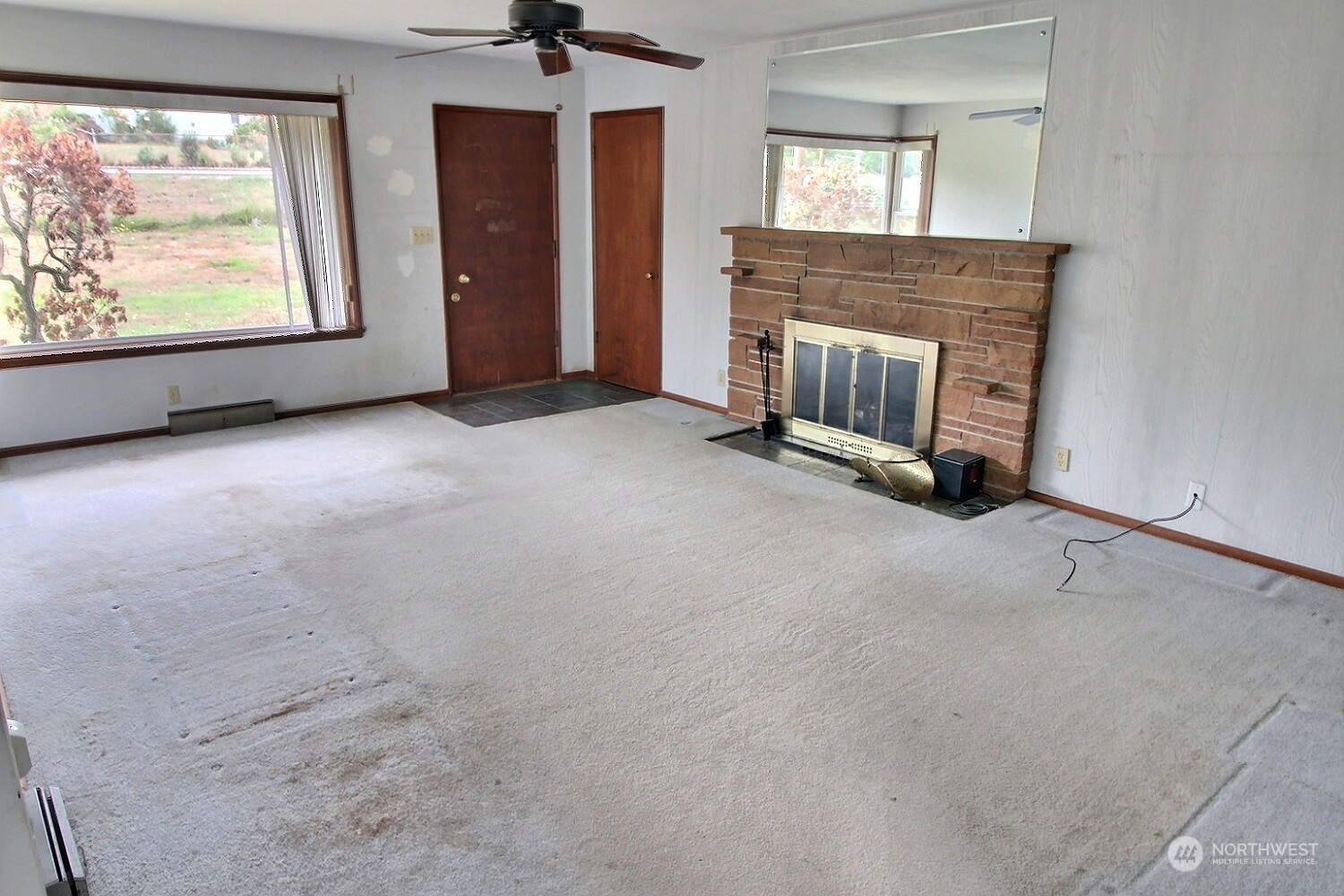 3619 Talbot Road South Renton, WA 98055 - Photo 6 of 27 an empty room with windows and fireplace