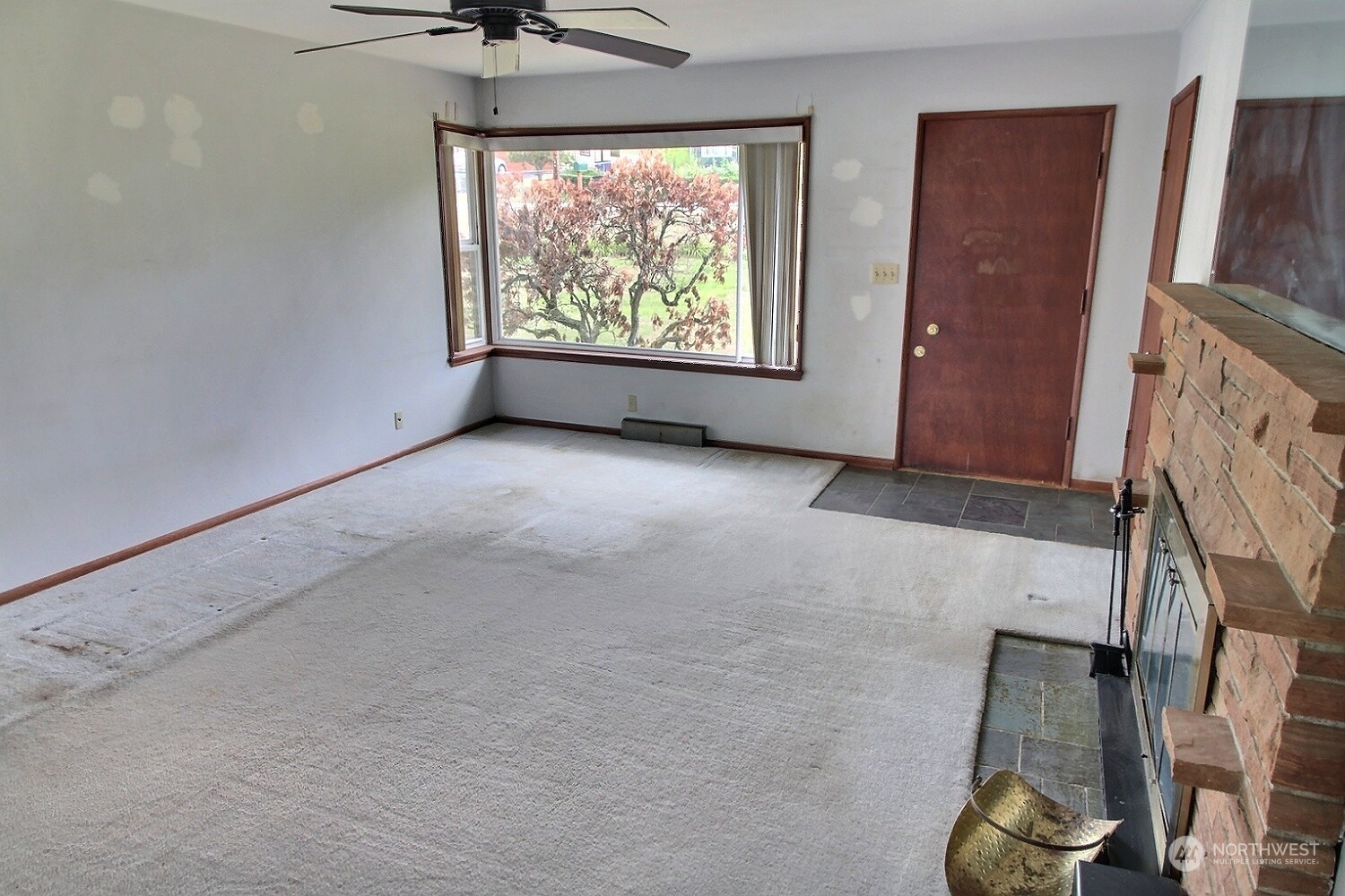 3619 Talbot Road South Renton, WA 98055 - Photo 7 of 27 an empty room with windows and a fireplace