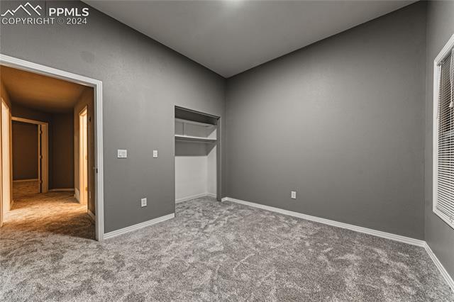 1027 County Road LL Fowler, CO 81039 - Photo 30 of 37 Unfurnished bedroom featuring a closet and carpet floors