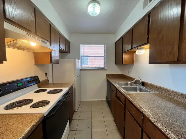 a kitchen that has a sink and a stove