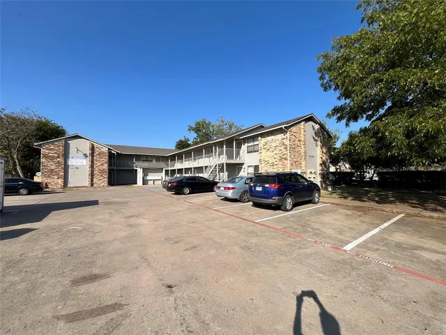 a view of a car park in front of a house