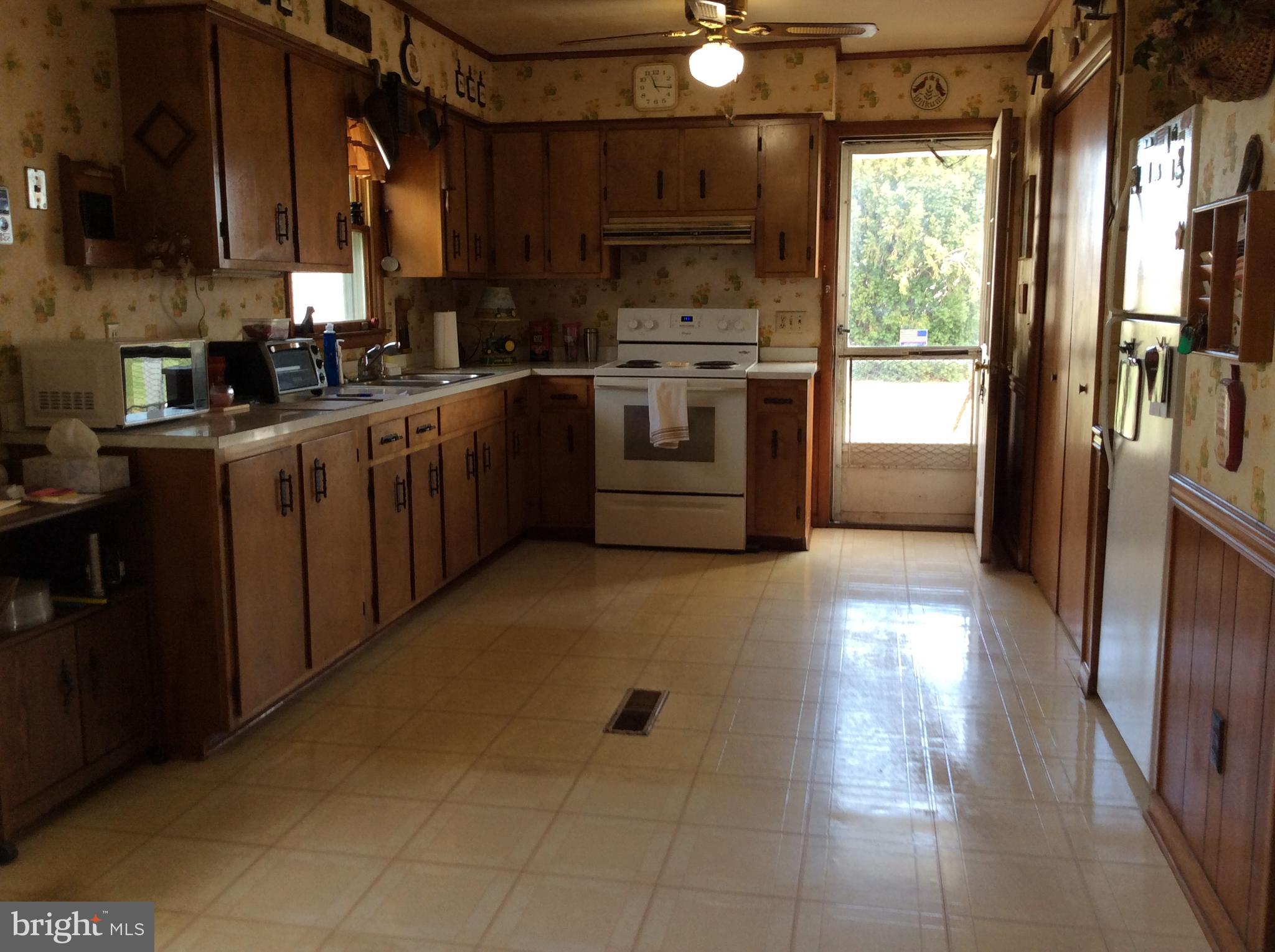 2001 Stulltown Road Millington, MD 21651 - Photo 11 of 18 a kitchen with stainless steel appliances granite countertop a stove a sink and a refrigerator