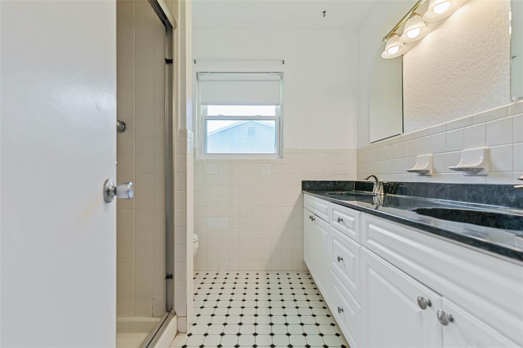 9 Crompton Place Palm Coast, FL 32137 - Photo 18 of 52 a bathroom with a sink a vanity and a mirror