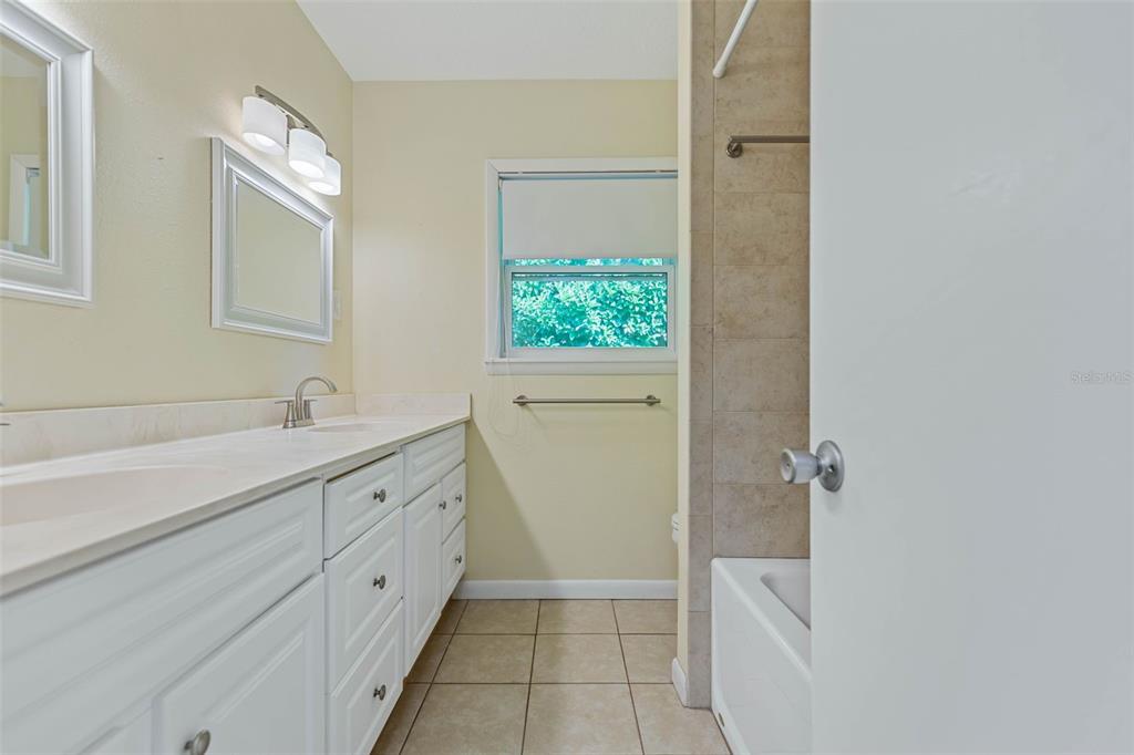 9 Crompton Place Palm Coast, FL 32137 - Photo 23 of 52 a spacious bathroom with a double vanity sink a large mirror and a shower