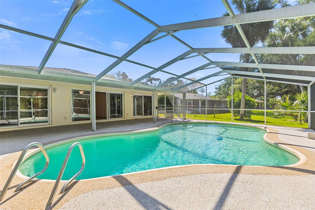 9 Crompton Place Palm Coast, FL 32137 - Photo 30 of 52 a view of a backyard with a swimming pool
