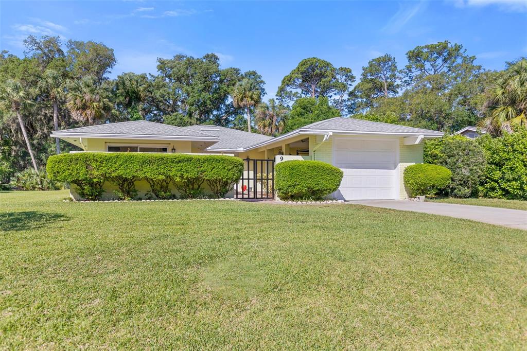 9 Crompton Place Palm Coast, FL 32137 - Photo 34 of 52 a front view of a house with garden