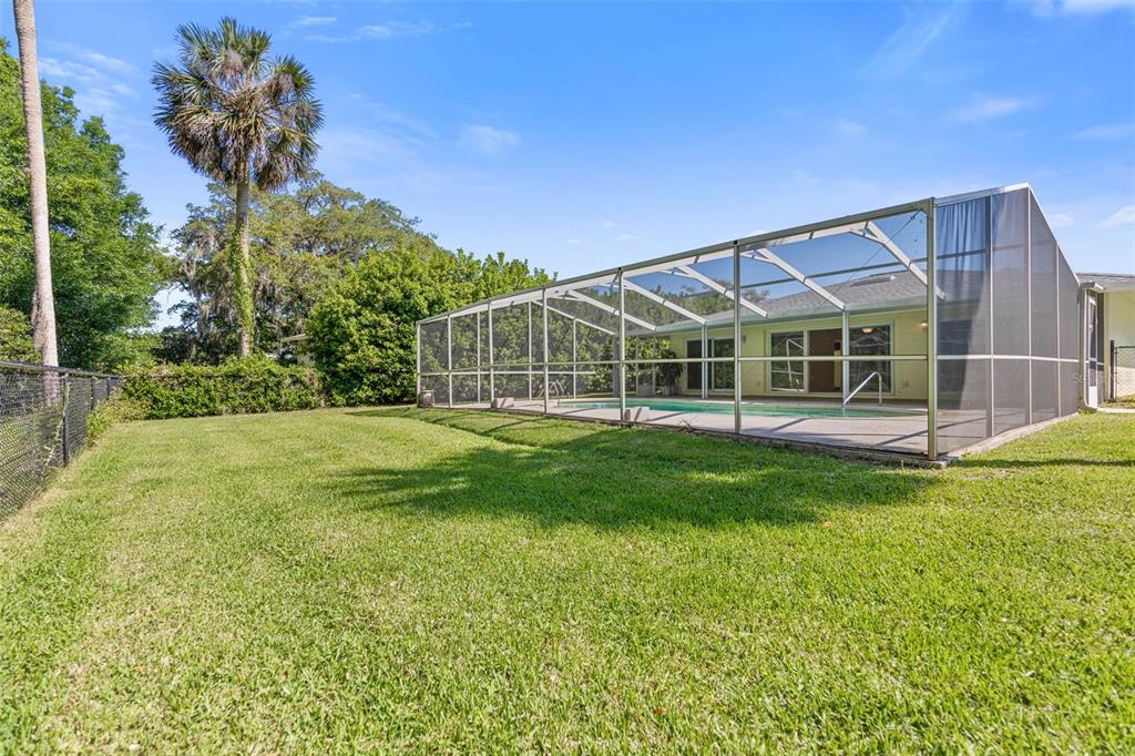 9 Crompton Place Palm Coast, FL 32137 - Photo 40 of 52 a view of a house with a backyard and a tree