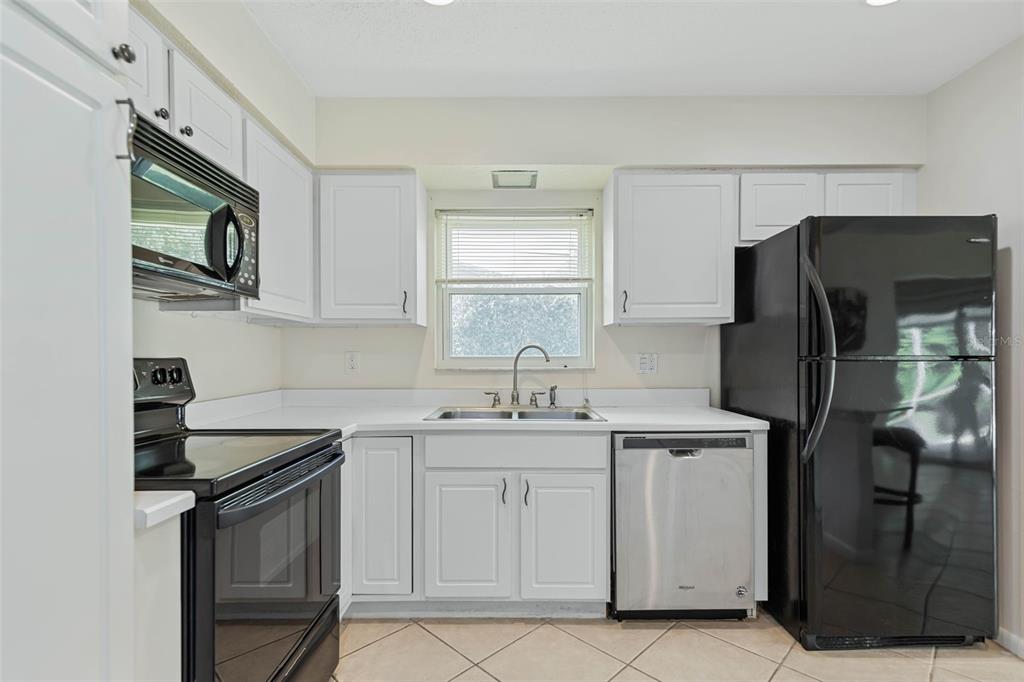 9 Crompton Place Palm Coast, FL 32137 - Photo 4 of 52 a kitchen with a sink stove and refrigerator
