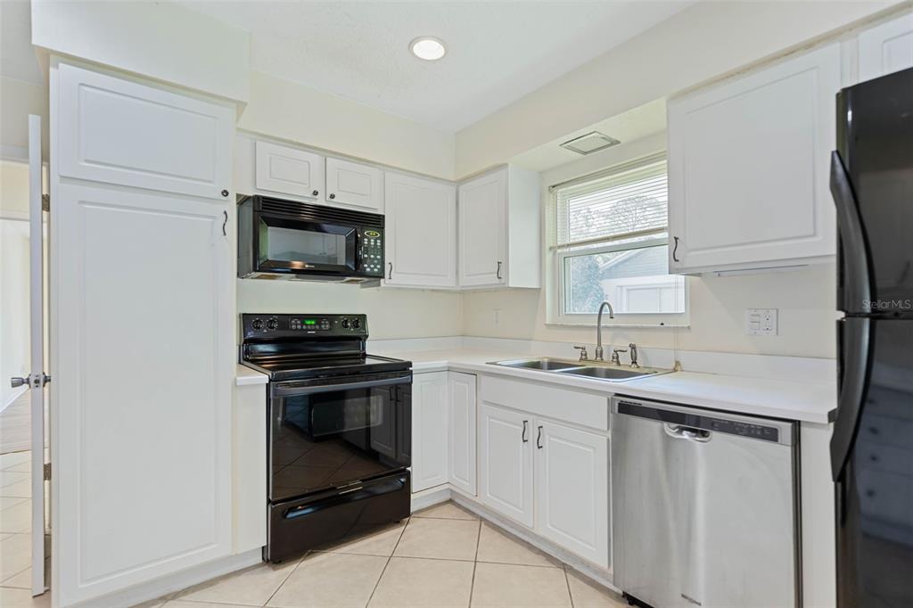 9 Crompton Place Palm Coast, FL 32137 - Photo 6 of 52 a kitchen with a sink stove and microwave