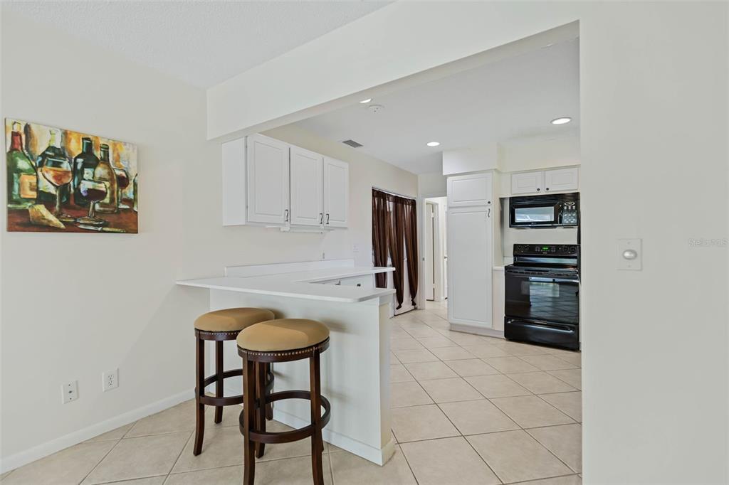9 Crompton Place Palm Coast, FL 32137 - Photo 8 of 52 a kitchen with stainless steel appliances granite countertop a refrigerator and a stove top oven