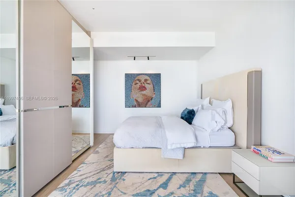 a bedroom with a large bed and a window