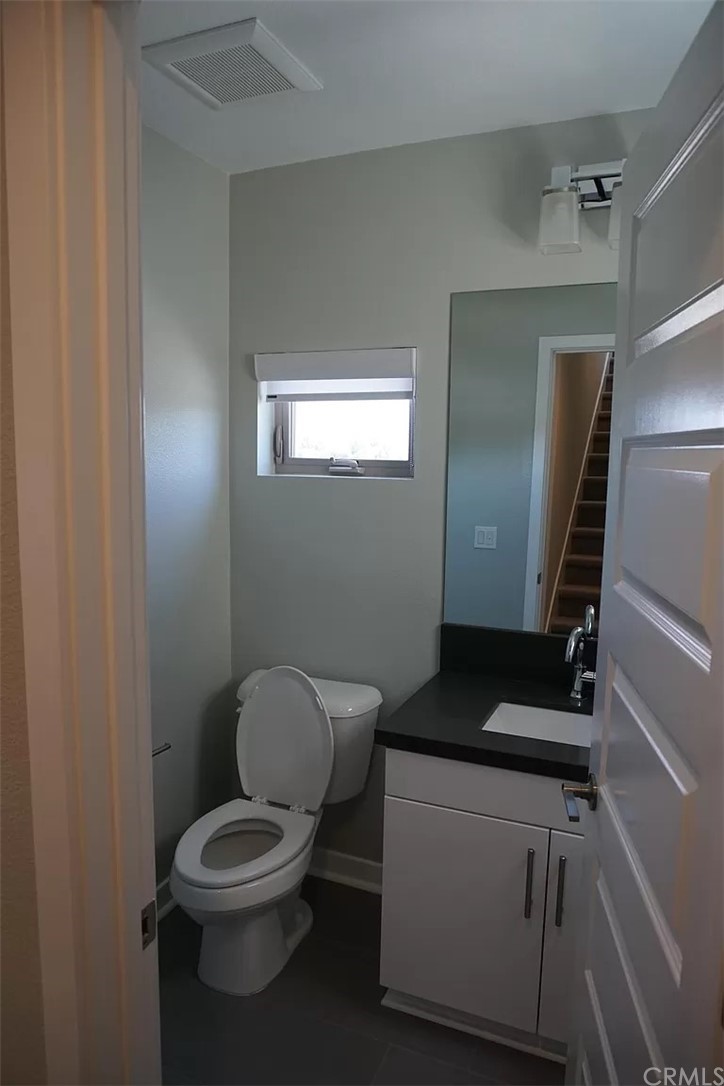 83 Ebb Tide Circle Newport Beach, CA 92663 - Photo 16 of 17 a bathroom with a toilet a sink and a window
