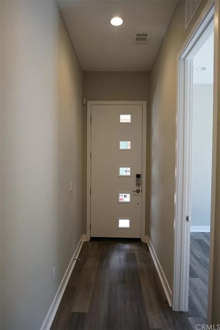 83 Ebb Tide Circle Newport Beach, CA 92663 - Photo 3 of 17 a view of a hallway with wooden floor