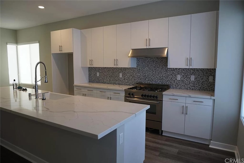 83 Ebb Tide Circle Newport Beach, CA 92663 - Photo 4 of 17 a kitchen with stainless steel appliances granite countertop a sink stove and refrigerator