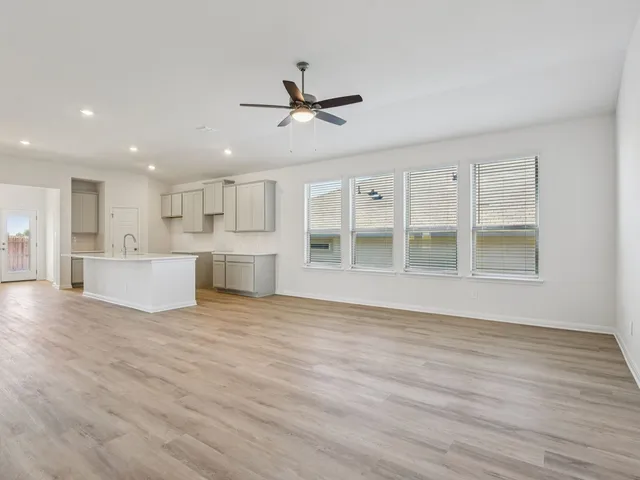 a view of a kitchen with wooden floor and a kitchen