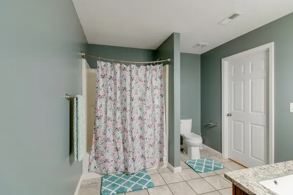 a bathroom with a shower curtain and sink