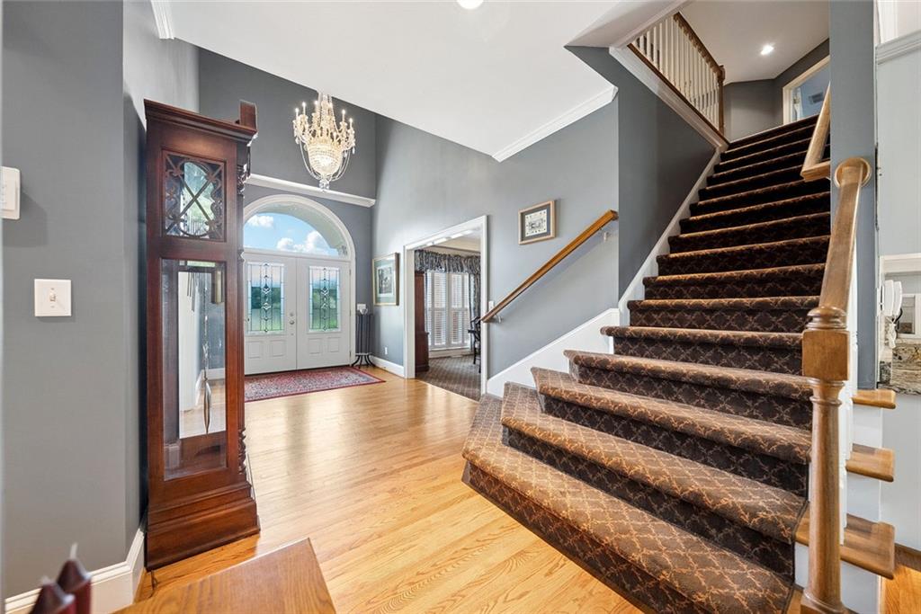 3309 Hamby Road Milton, GA 30004 - Photo 25 of 95 a view of staircase with lots of frames on wall and a large window