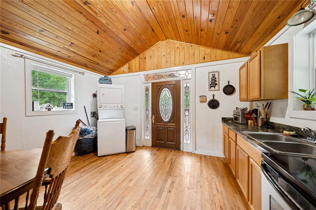 3309 Hamby Road Milton, GA 30004 - Photo 66 of 95 a kitchen with stainless steel appliances a stove a refrigerator a sink a dining table and chairs with wooden floor