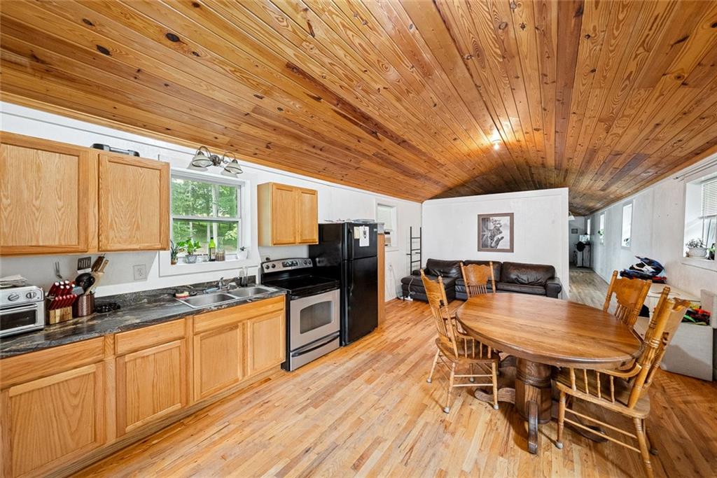 3309 Hamby Road Milton, GA 30004 - Photo 67 of 95 a dining hall with stainless steel appliances granite countertop a stove a sink dishwasher and cabinets with wooden floor