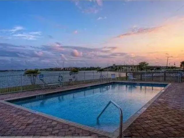 a view of a swimming pool with an outdoor seating