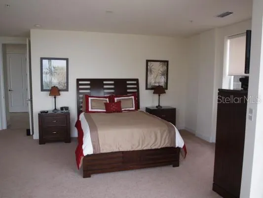a bed room with a bed and dresser