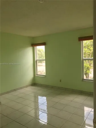 a view of a closet area with hardwood