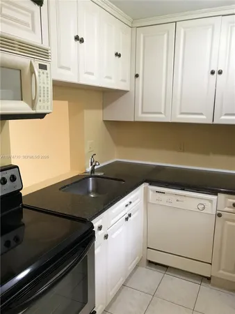 a kitchen with cabinets and stainless steel appliances