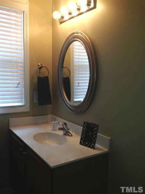 4615 Merendino Street Raleigh, NC 27606 - Photo 22 of 24 a bathroom with a sink and a mirror
