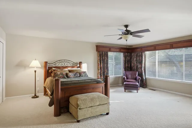 a bedroom with furniture and a large window