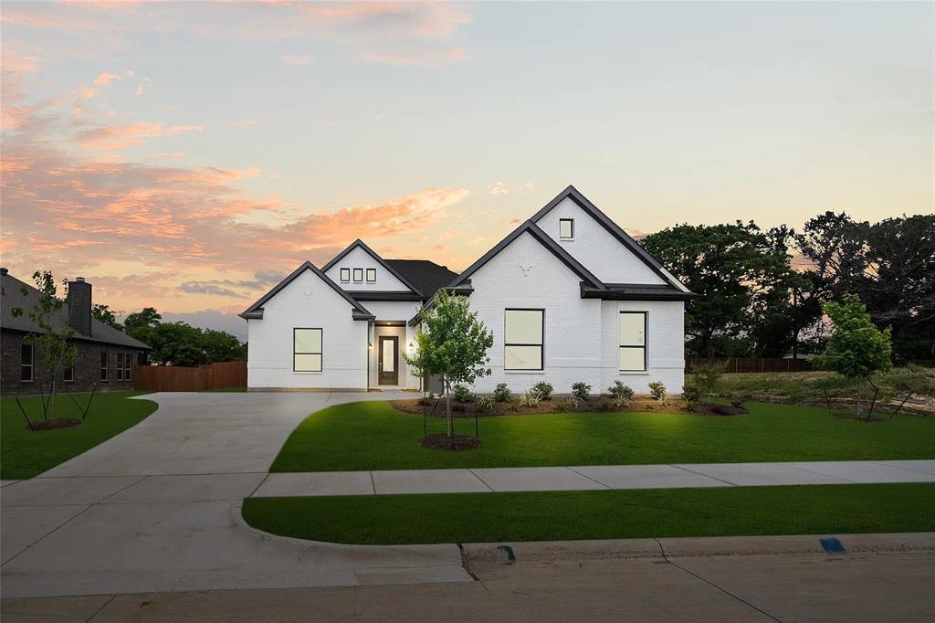 4021 Alpine Street Midlothian, TX 76065 - Photo 1 of 18 Contemporary single-story residence featuring white brick exterior, black trim accents, a dark roof, and a prominent front-facing gable