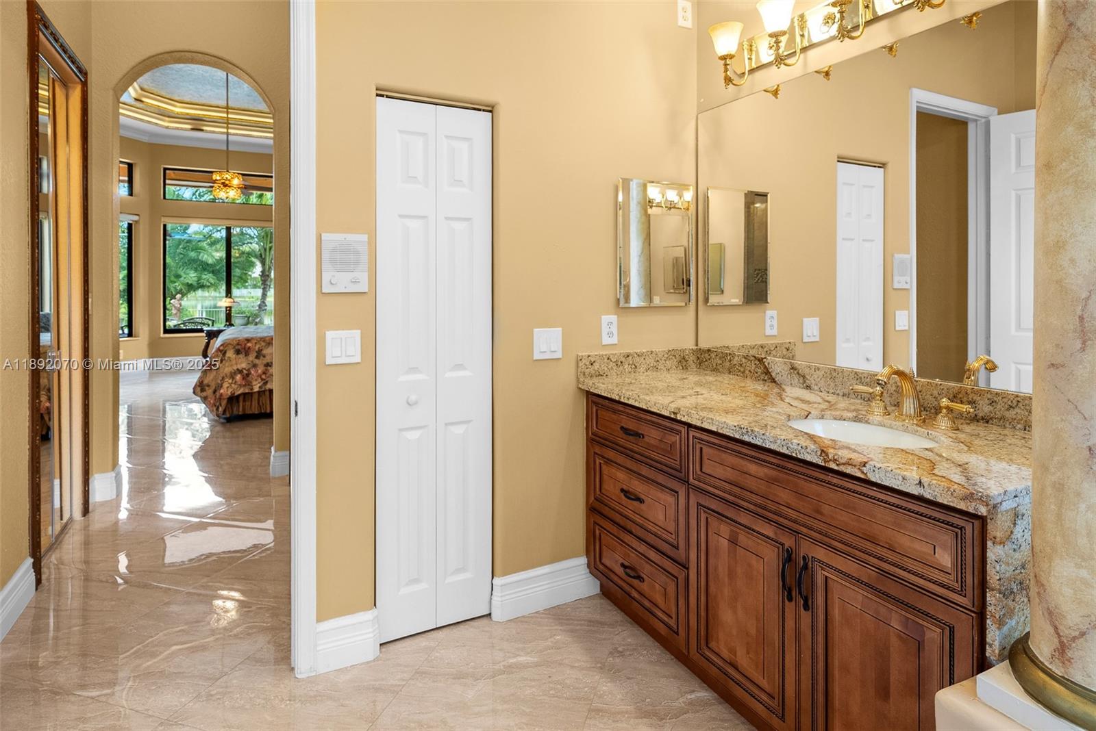 19230 Southwest 30th Street Miramar, FL 33029 - Photo 18 of 45 a bathroom with a granite countertop sink and a mirror