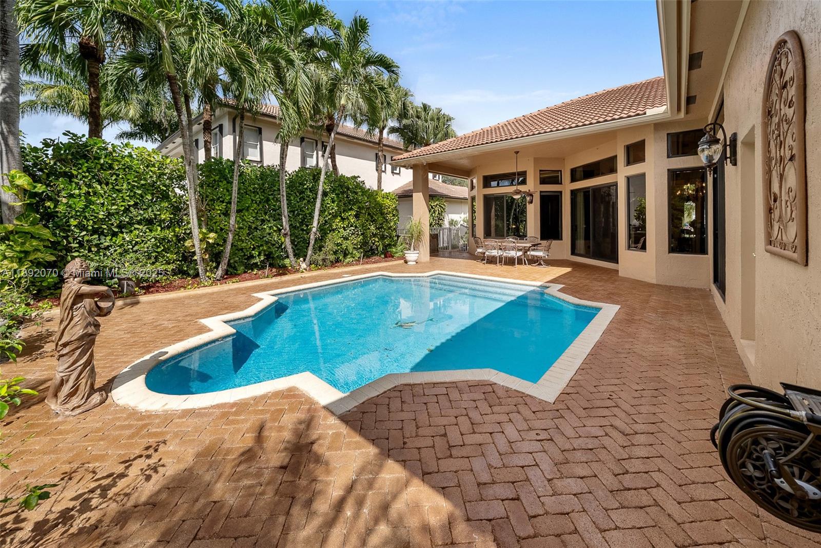 19230 Southwest 30th Street Miramar, FL 33029 - Photo 26 of 45 a view of swimming pool with lounge chair and dinning table under an umbrella