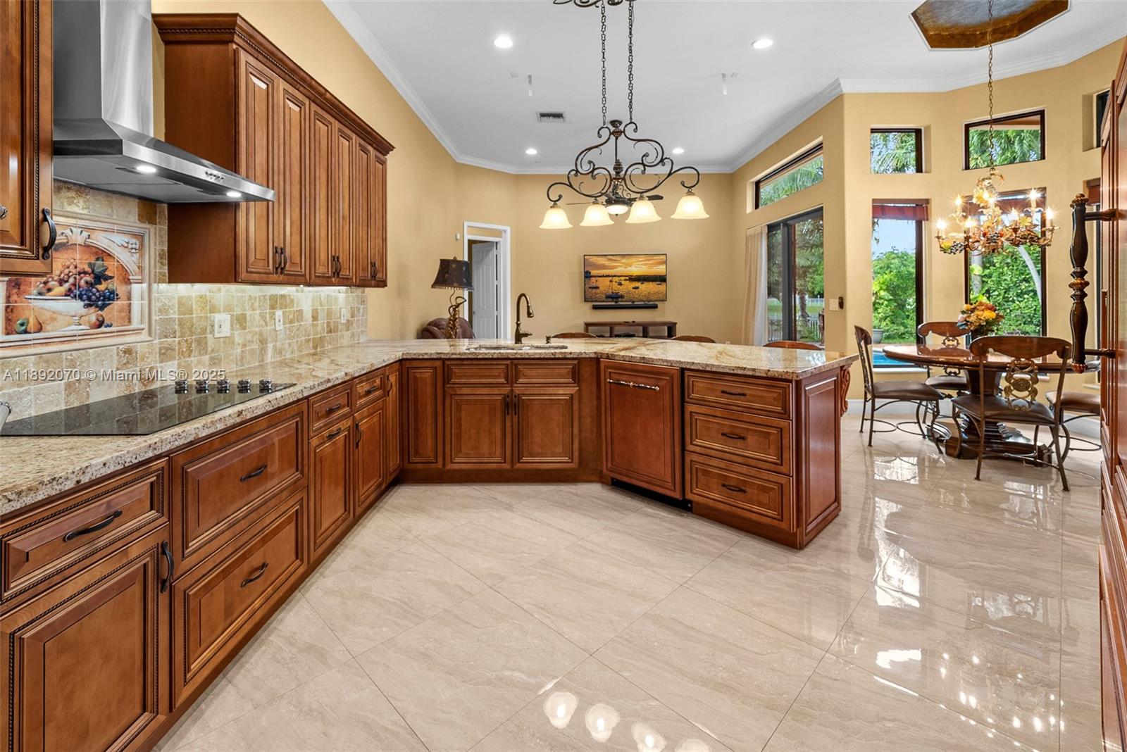 19230 Southwest 30th Street Miramar, FL 33029 - Photo 28 of 45 a large kitchen with stainless steel appliances granite countertop a sink counter space cabinets and a large window